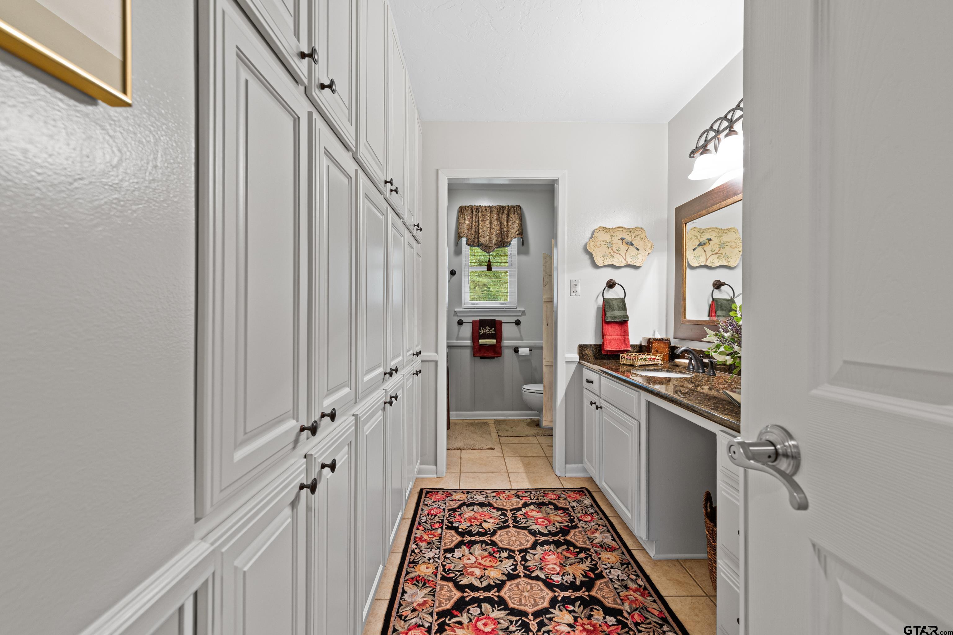 1610 Pinecrest Street Gilmer, TX 75644 - Photo 29 of 40 a kitchen with granite countertop a stove and a sink