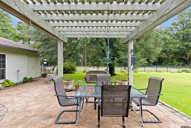 an aerial view of a house with swimming pool garden and patio