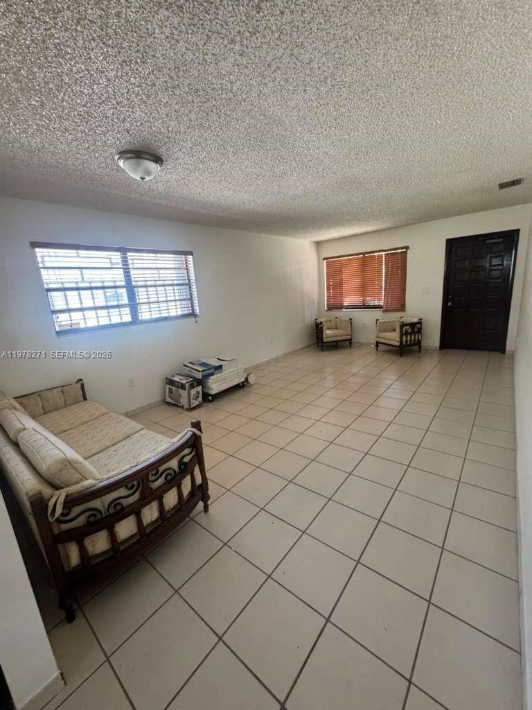 252 Northwest 48th Place, Unit 252 Miami, FL 33126 - Photo 11 of 15 a room with furniture and window