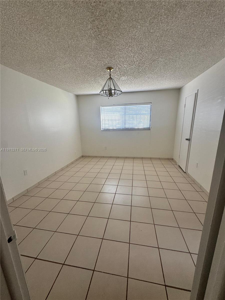 252 Northwest 48th Place, Unit 252 Miami, FL 33126 - Photo 2 of 15 a view of an empty room and a window