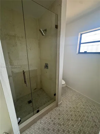 a bathroom with a glass door shower