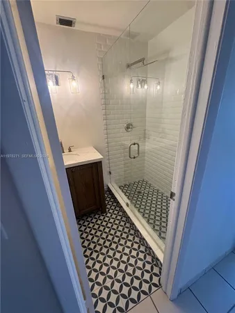a bathroom with a glass door shower