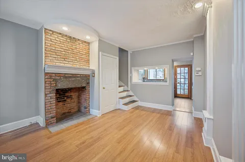 an empty room with windows and a fireplace
