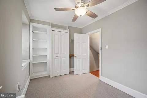 a view of an empty room with a ceiling fan