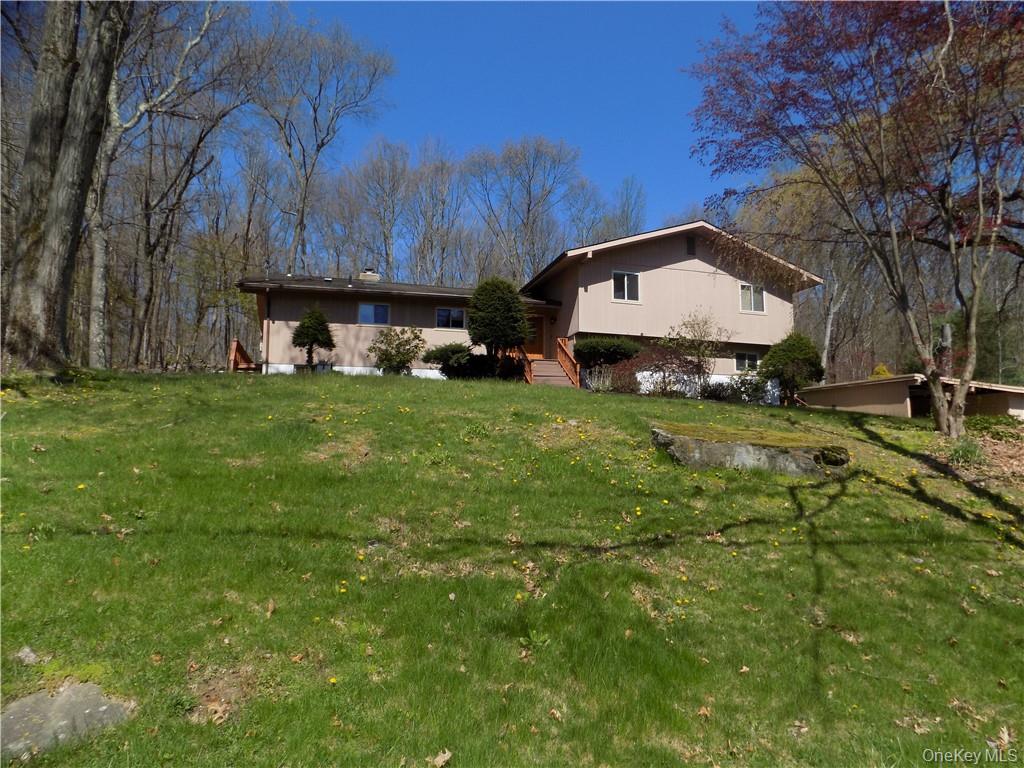 a view of a backyard with table and chairs and a large tree