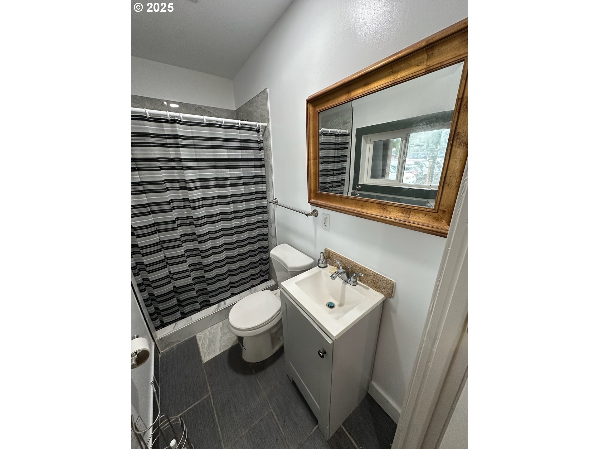 11803 Southeast Division Street, Unit 38 Portland, OR 97266 - Photo 22 of 24 a bathroom with a toilet a sink and mirror