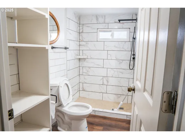 a bathroom with a toilet and a shower