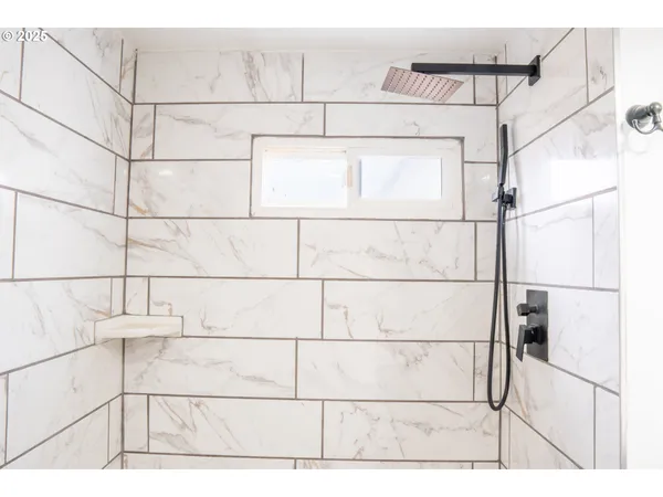 a picture of a bathroom with a shower