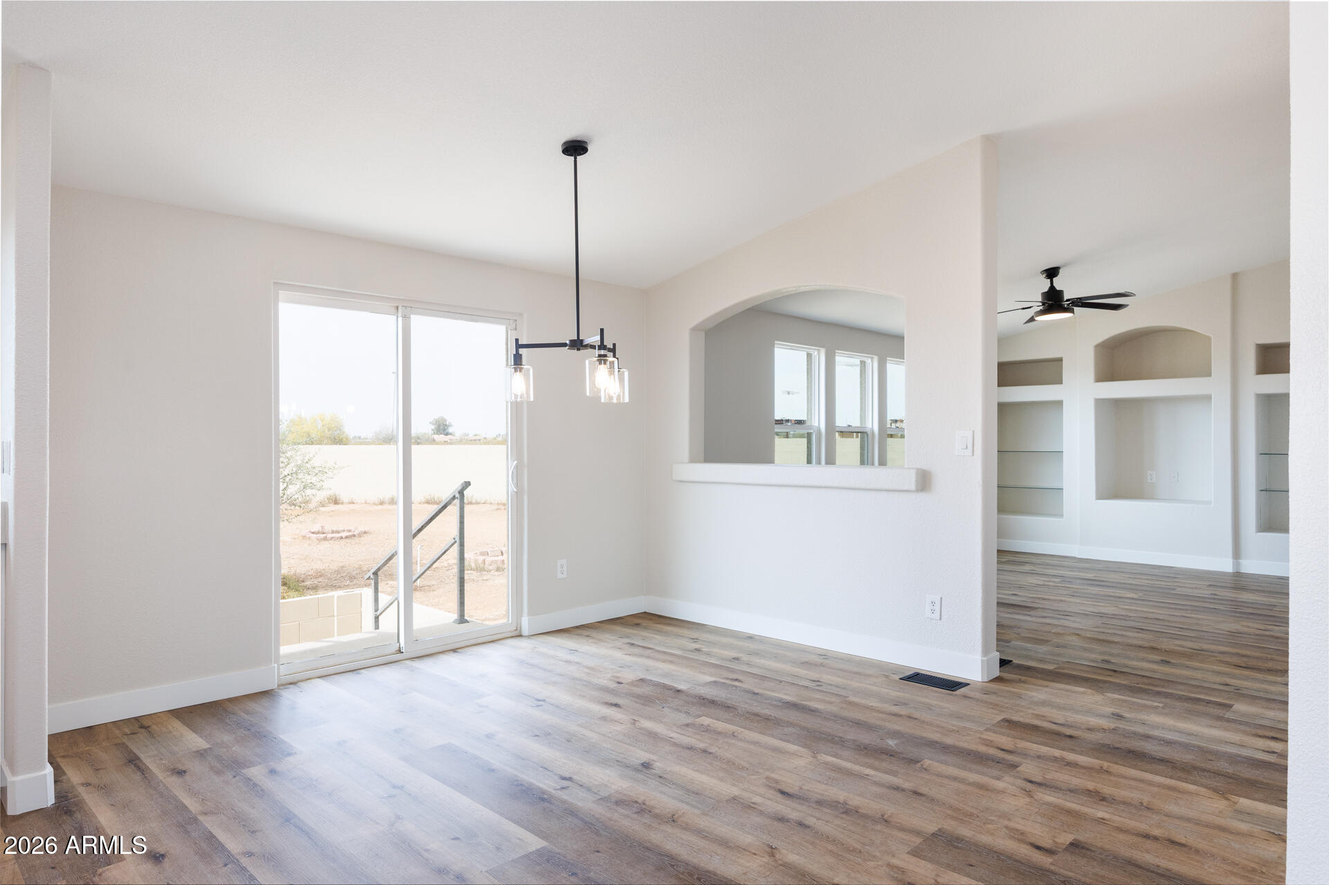 10290 North Katsina Road Casa Grande, AZ 85122 - Photo 10 of 51 a view of an empty room with window and wooden floor