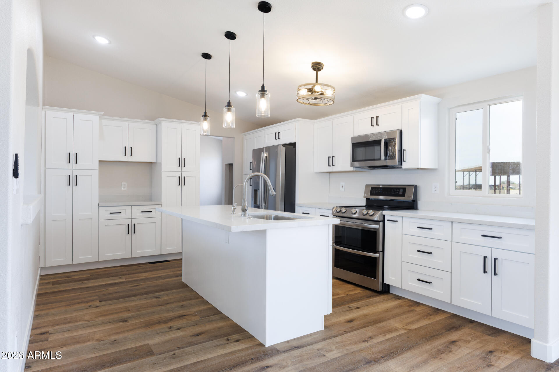 10290 North Katsina Road Casa Grande, AZ 85122 - Photo 13 of 51 a kitchen with white cabinets and stainless steel appliances