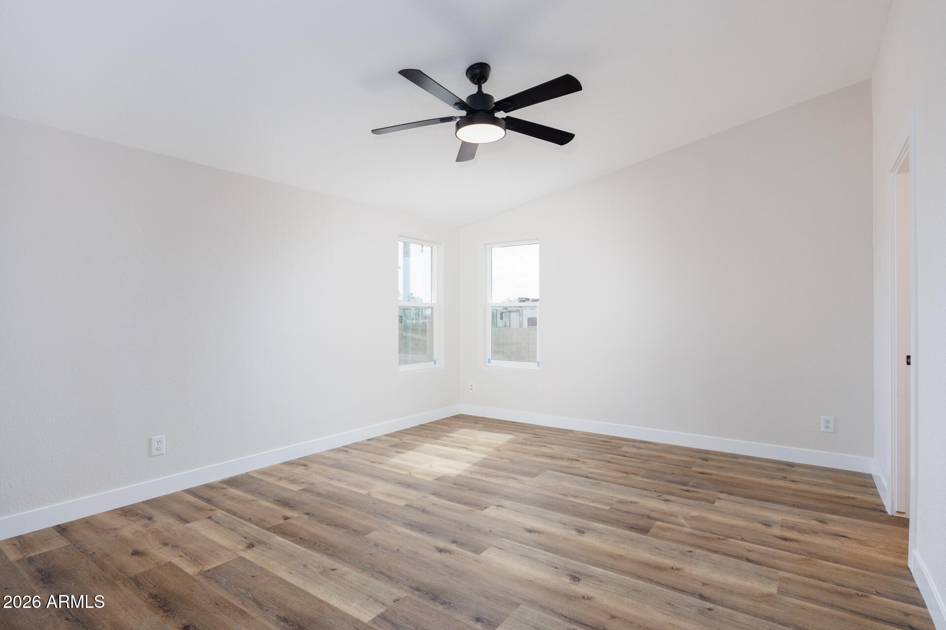 10290 North Katsina Road Casa Grande, AZ 85122 - Photo 20 of 51 a view of empty room with wooden floor and ceiling fan