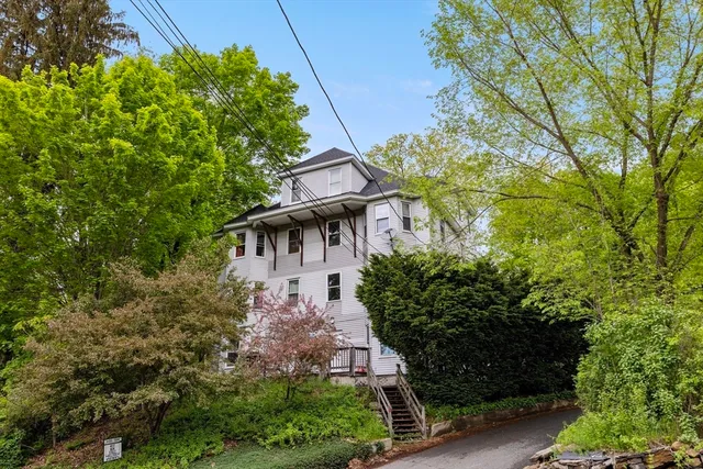a front view of a house with garden