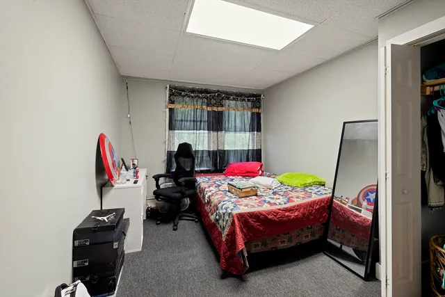 a bedroom with bed and a window