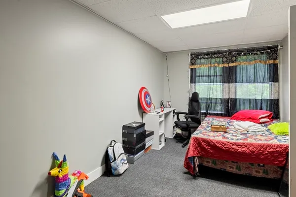 a bedroom with bed and a window