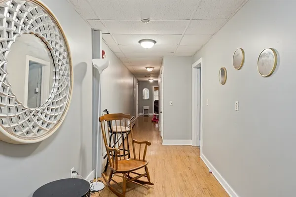 a view of a hallway with dining area and chandelier