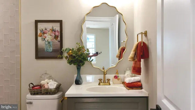 a bathroom with a bathtub sink mirror vanity and toilet