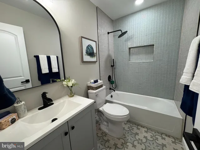 an empty room with wooden floor fireplace and windows