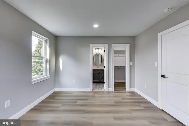 a view of a room with wooden floor and a sink