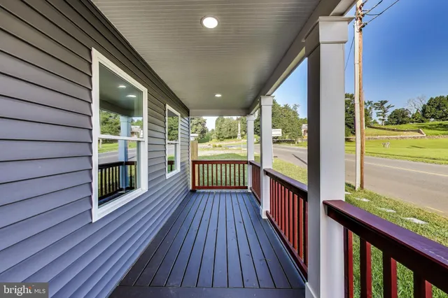 a kitchen with stainless steel appliances kitchen island granite countertop a sink refrigerator and cabinets
