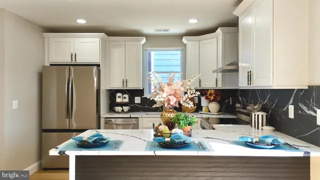 a view of a hallway with wooden floor and a chandelier