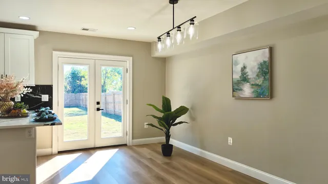 a view of an empty room with a window and fireplace