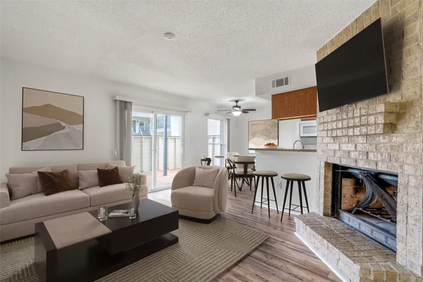a living room with fireplace furniture and a flat screen tv