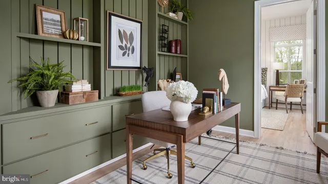 a living room with furniture a large window and wooden floor