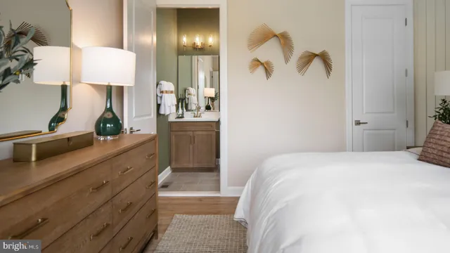a living room with furniture kitchen view and a wooden floor