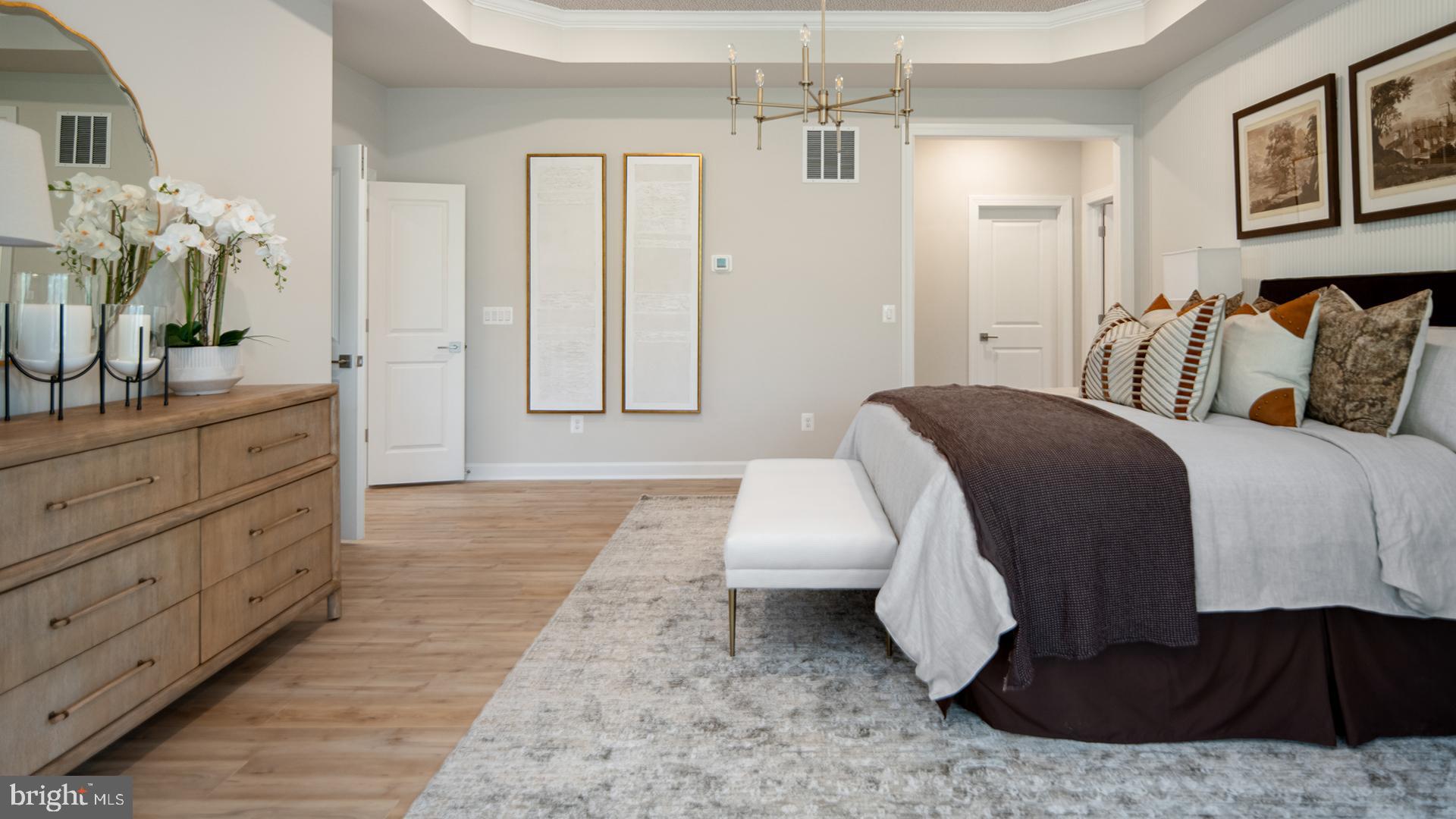 Tbb While Away Drive, Unit RICHMOND Bowie, MD 20716 - Photo 69 of 99 a spacious bedroom with a bed a mirror and lamp