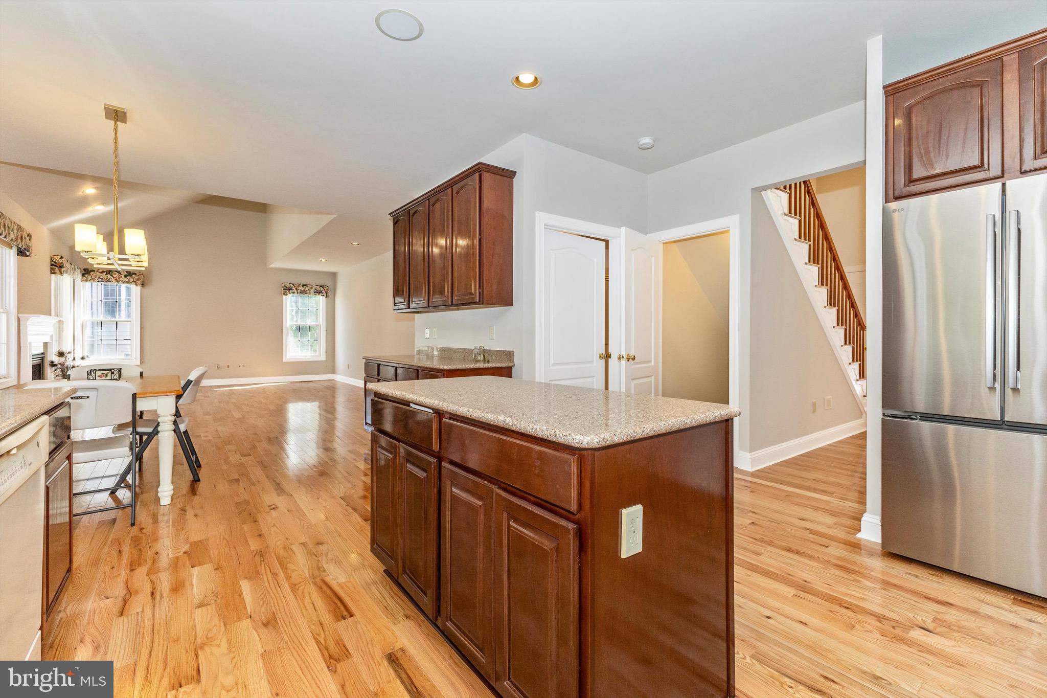10213 Deep Skies Drive Laurel, MD 20723 - Photo 20 of 56 a kitchen with kitchen island a counter top space a sink a refrigerator and a stove top oven