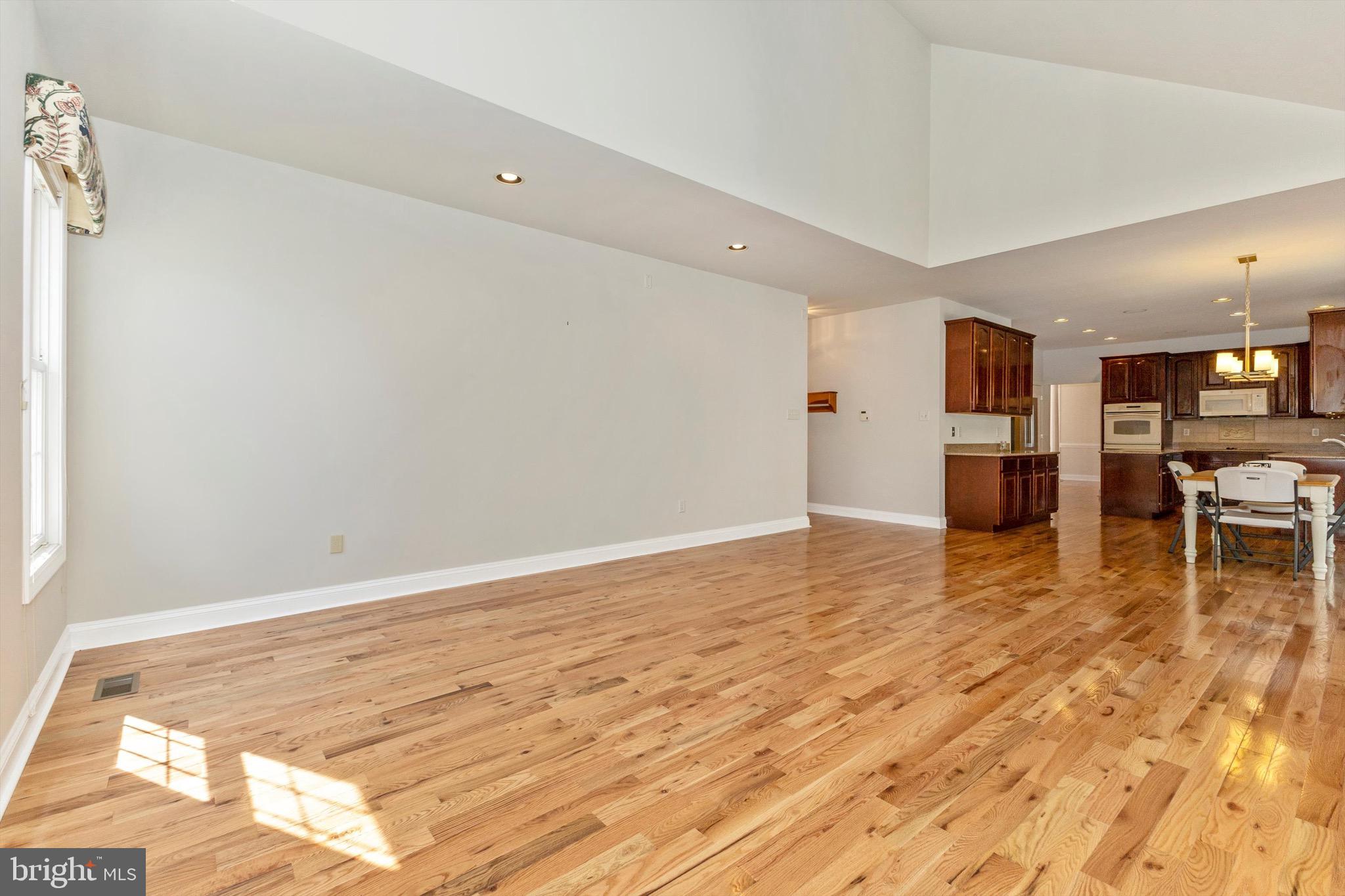 10213 Deep Skies Drive Laurel, MD 20723 - Photo 27 of 56 a view of a kitchen with a refrigerator and wooden floor