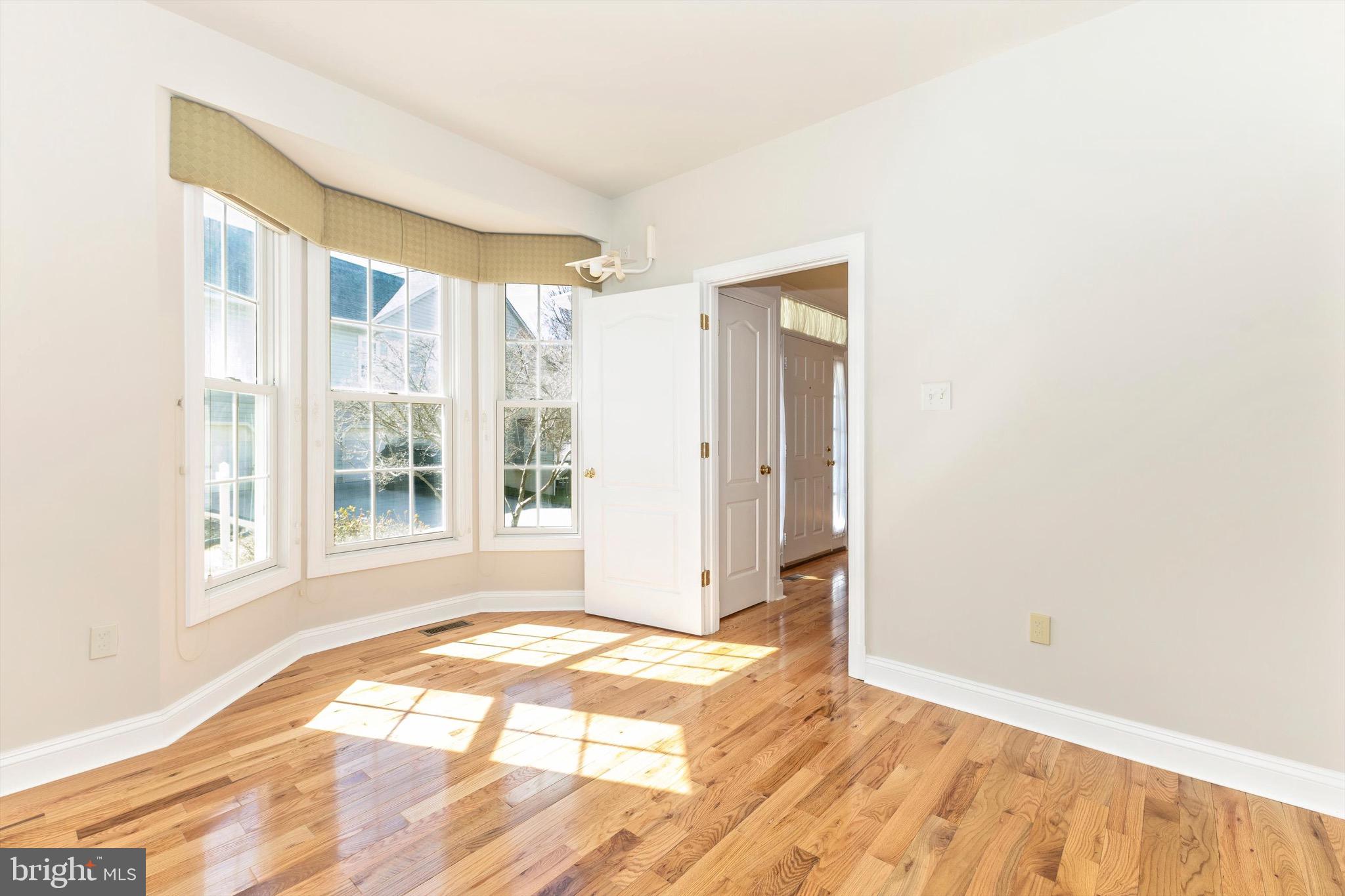 10213 Deep Skies Drive Laurel, MD 20723 - Photo 28 of 56 a view of an empty room with wooden floor and a window