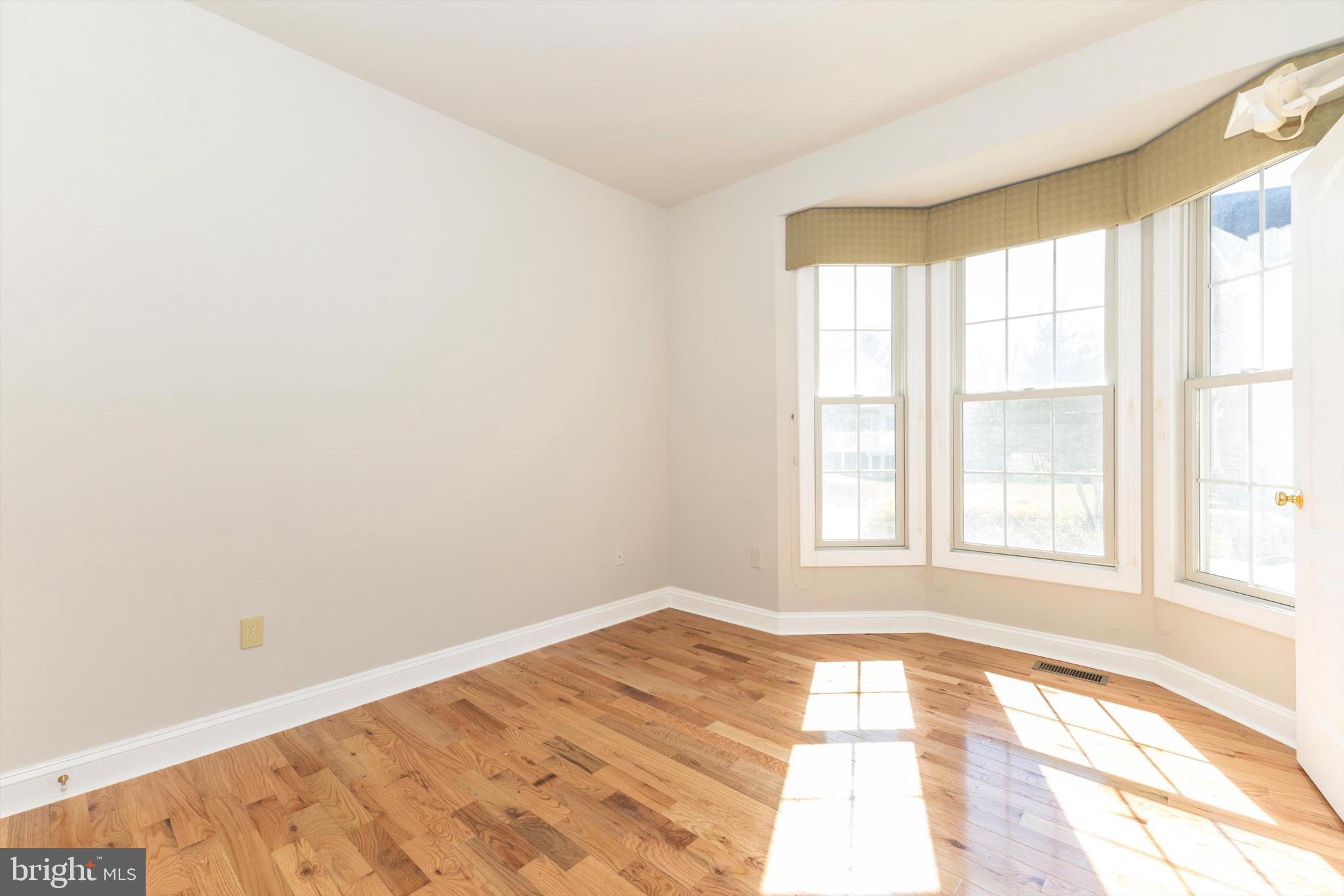 10213 Deep Skies Drive Laurel, MD 20723 - Photo 29 of 56 a view of empty room with wooden floor and fan