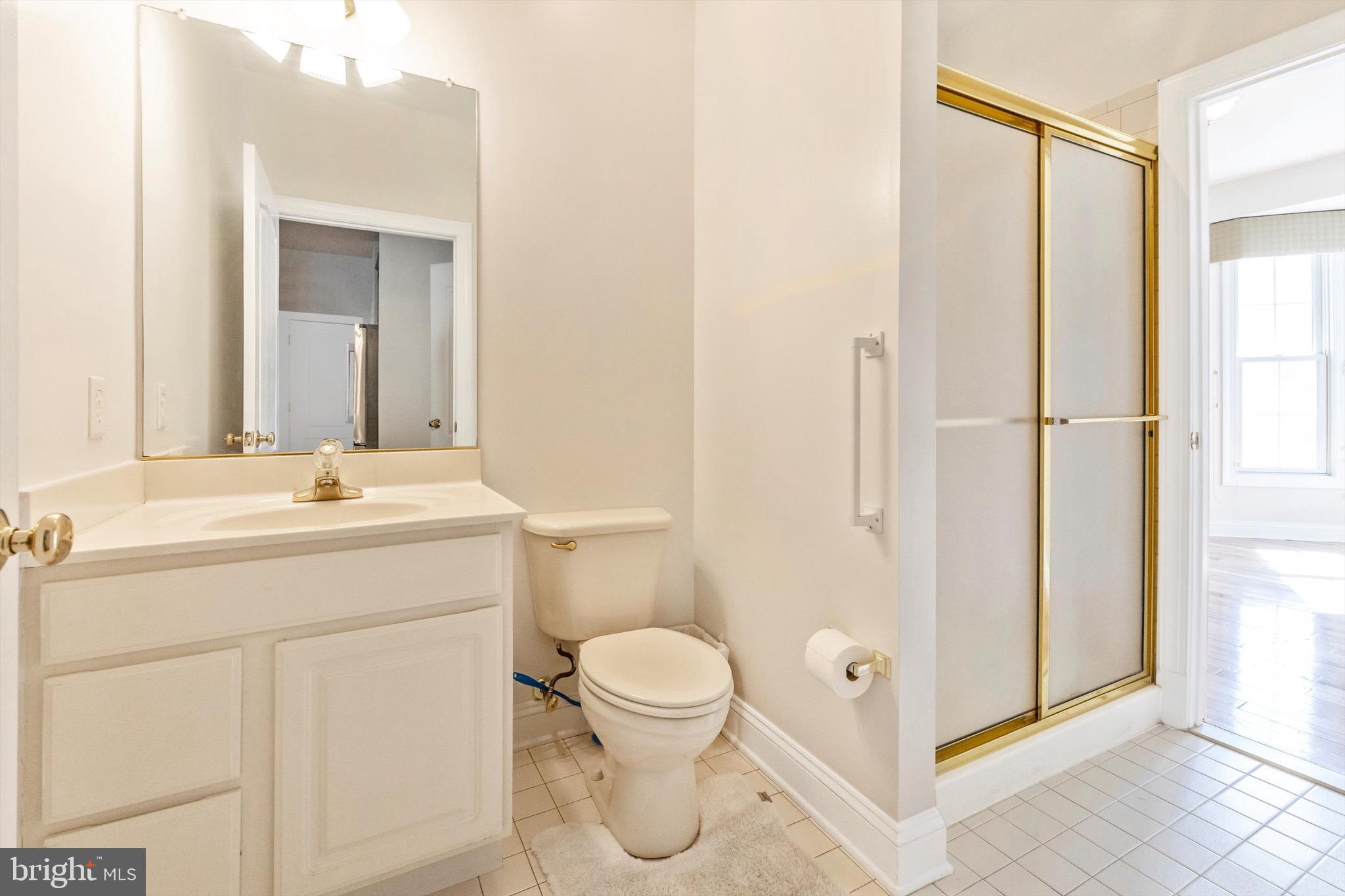 10213 Deep Skies Drive Laurel, MD 20723 - Photo 30 of 56 a bathroom with a toilet a sink and a mirror