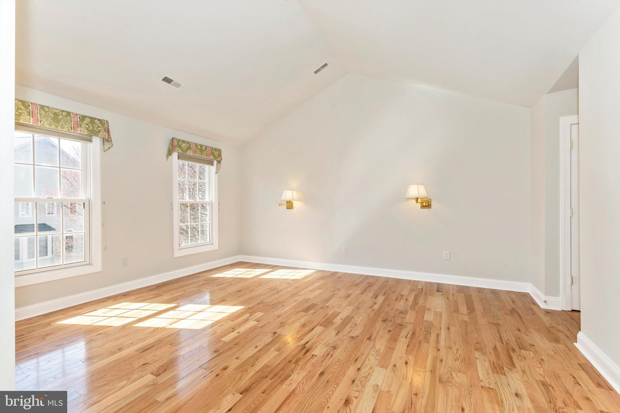 10213 Deep Skies Drive Laurel, MD 20723 - Photo 33 of 56 an empty room with wooden floor and windows