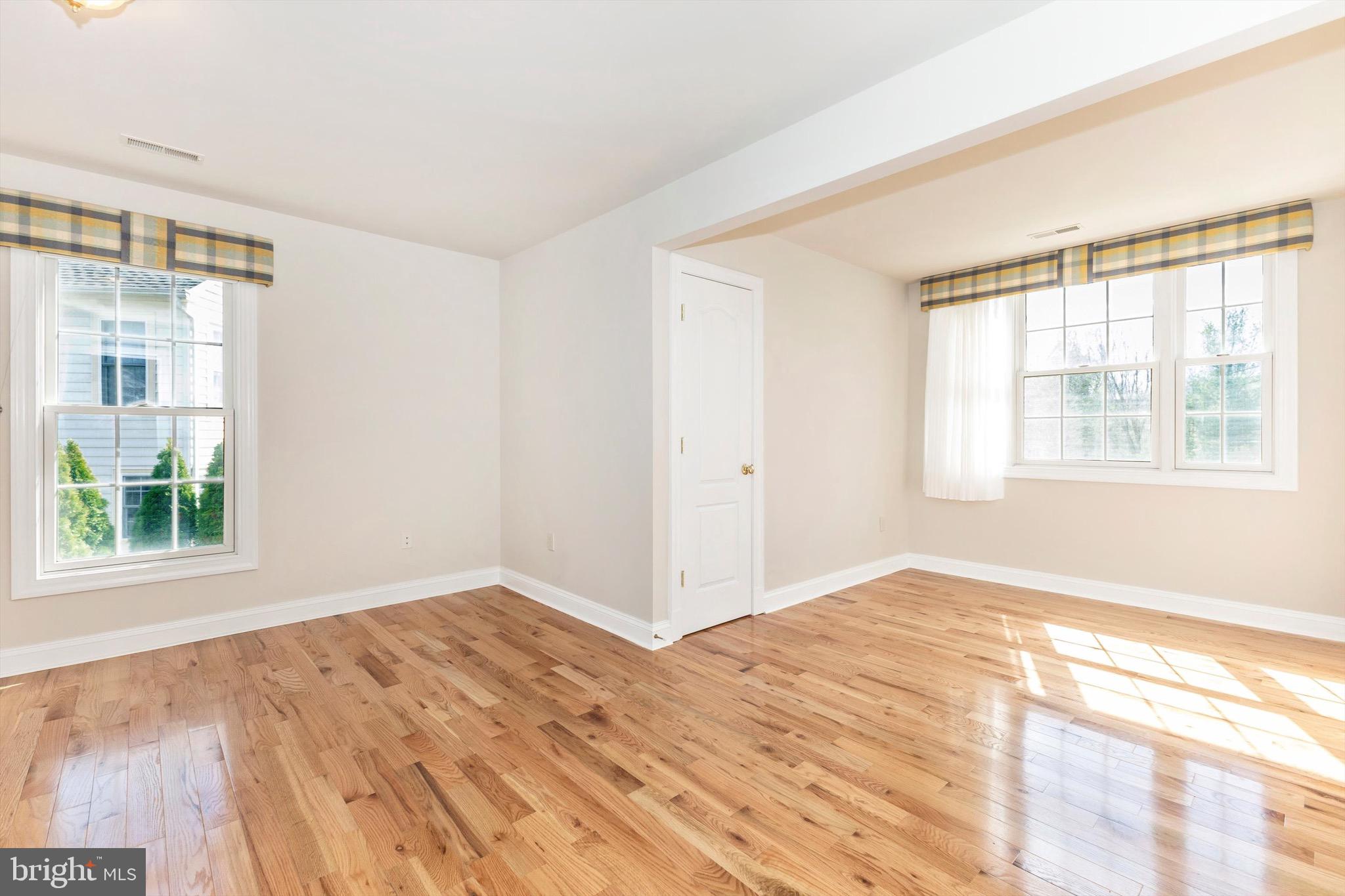10213 Deep Skies Drive Laurel, MD 20723 - Photo 39 of 56 a view of empty room with wooden floor and fan