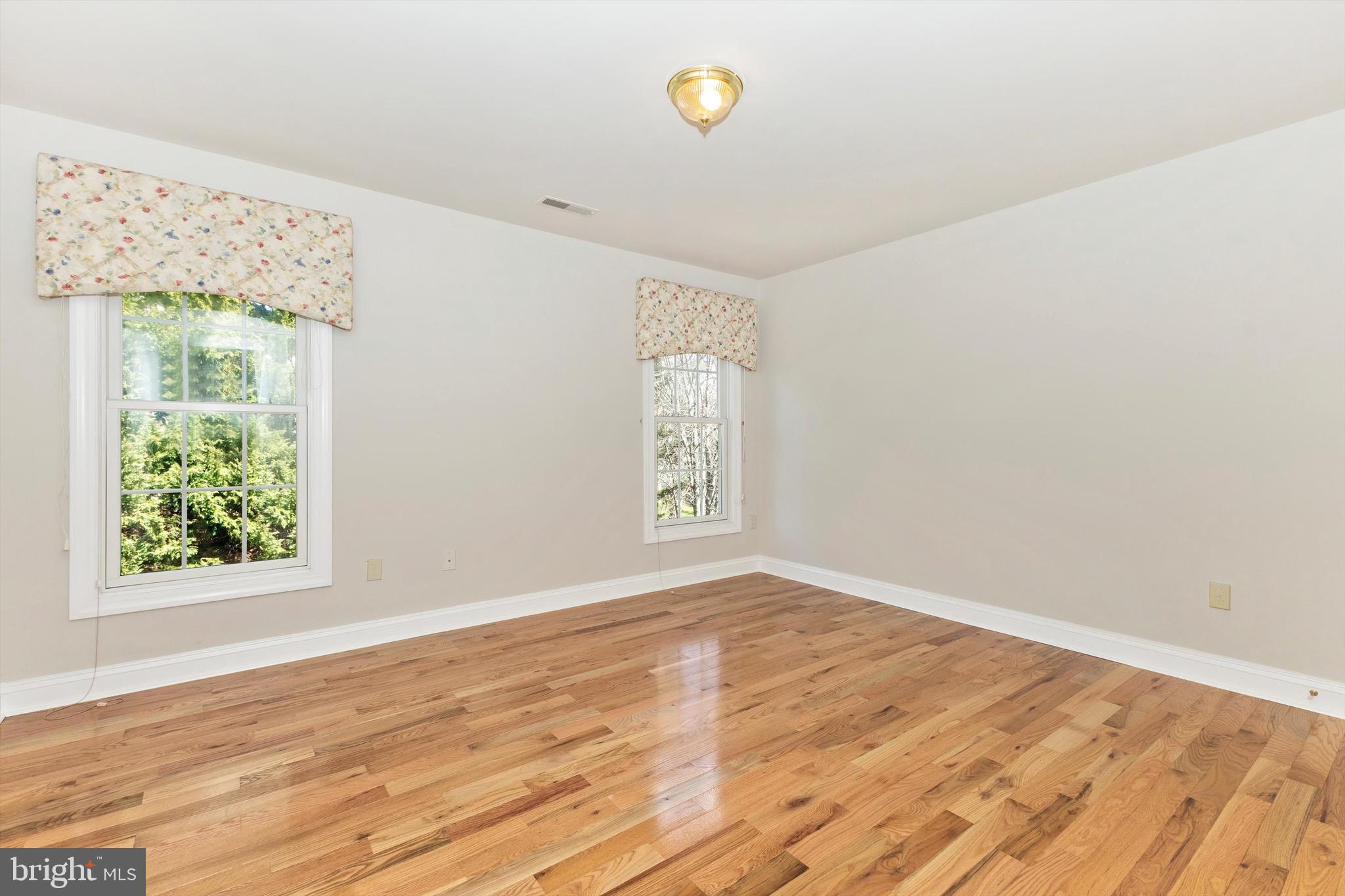 10213 Deep Skies Drive Laurel, MD 20723 - Photo 41 of 56 a view of an empty room with wooden floor and a window