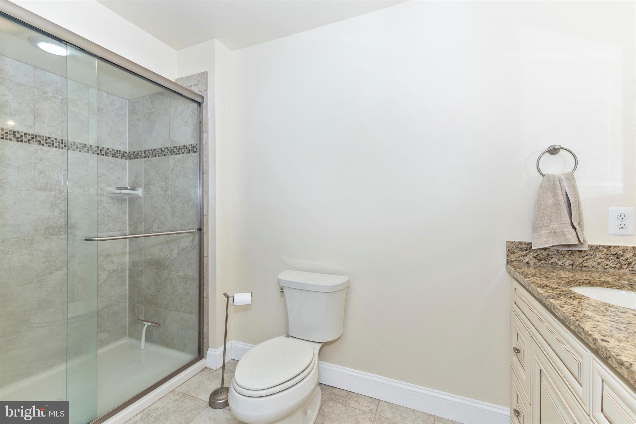 10213 Deep Skies Drive Laurel, MD 20723 - Photo 49 of 56 a bathroom with a granite countertop bathtub shower sink and toilet