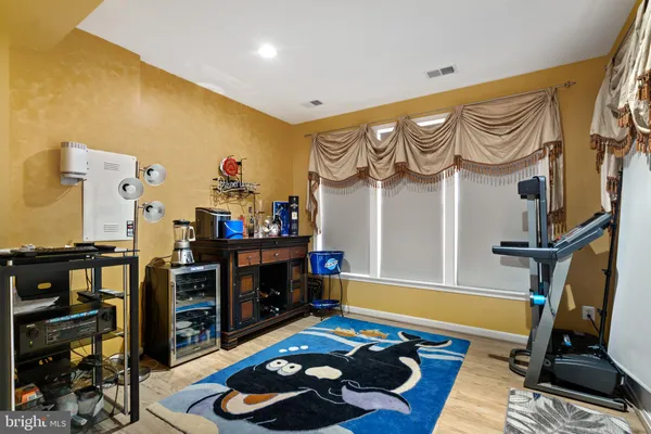a bedroom with furniture and wooden floor