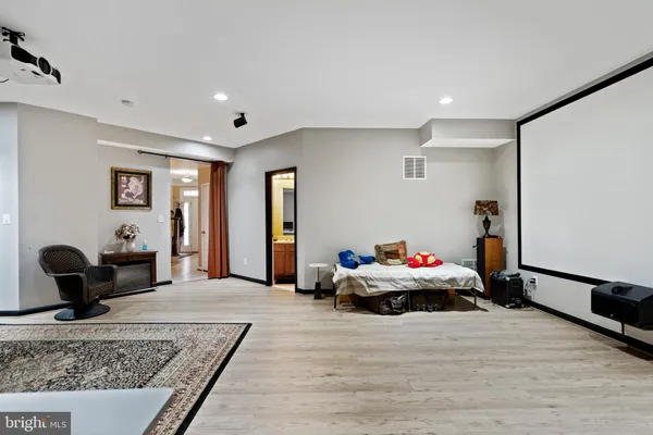 a kitchen with stainless steel appliances granite countertop a stove top oven a sink dishwasher a dining table and chairs with wooden floor