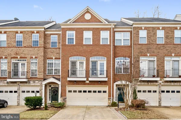 a front view of a residential apartment building with a yard