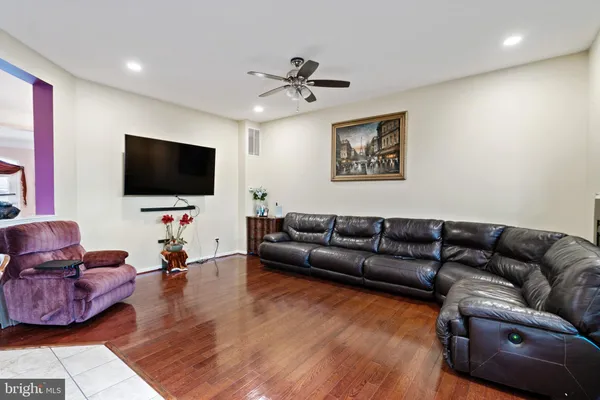 a living room with furniture and a view of kitchen