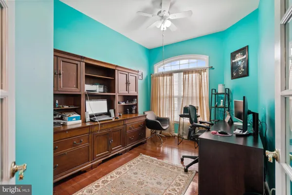 a living room with fireplace furniture and a wooden floor
