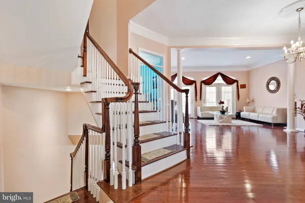 a living room with fireplace furniture and a chandelier