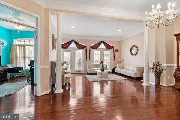 a living room with furniture and a chandelier