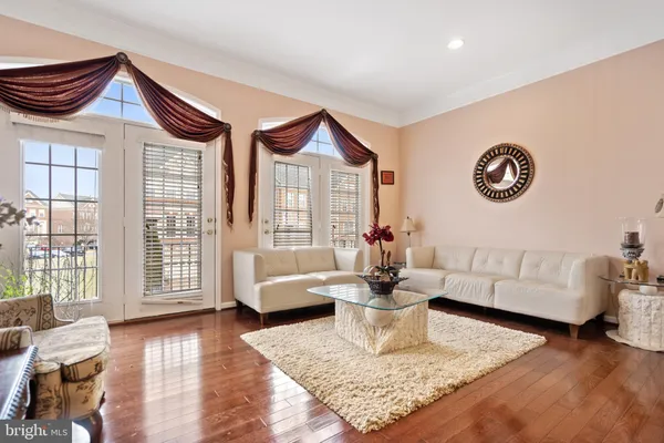 a living room with furniture gaming tables and a potted plant