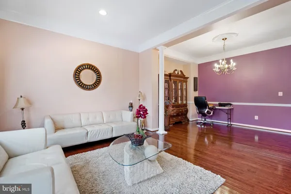 a view of entryway dining room and hall with wooden floor