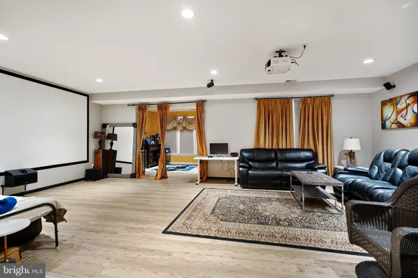 a living room with fireplace furniture and a rug