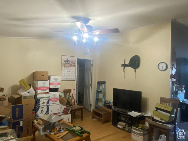 4963 20810 West Duchesne, UT 84021 - Photo 8 of 28 Living room with light wood-style floors, ornamental molding, and a ceiling fan