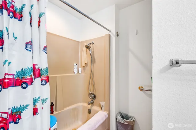 a bathroom with a bath tub a sink and a shower curtain